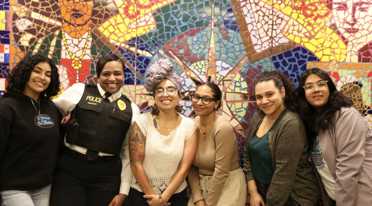 Representatives from La Casa Latina pose with Capt. McCoy.