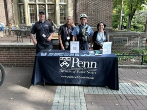 DPS personnel standing behind a table covered with giveaways and brochures. 