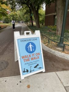 A-frame sign which reads: "Walk it on the Walk"