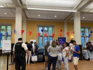 a group of people gather and talk inside of Houston Hall, Penn's student center