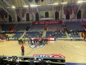 DPS personnel pose for a photo on the court of the historic Palestra