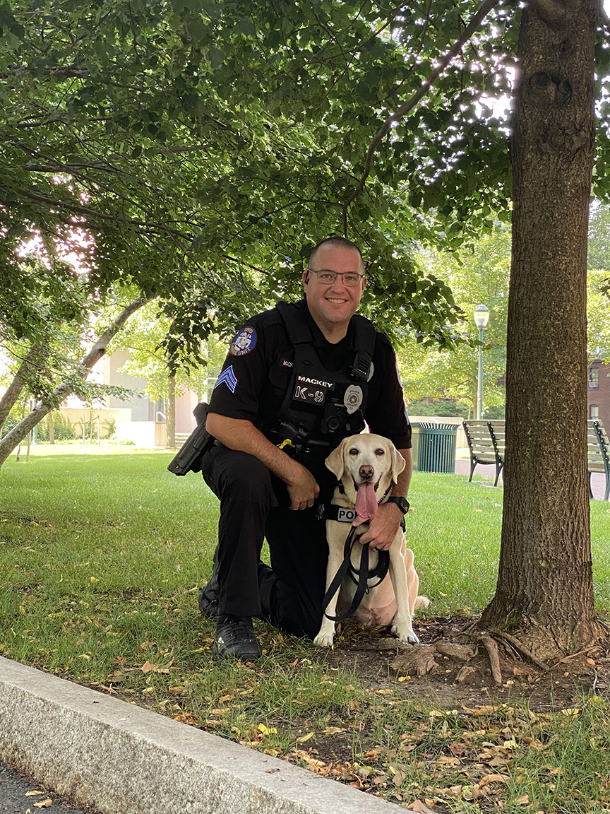 K9 Officer Zzisa poses under a tree with Sgt. Mackey.