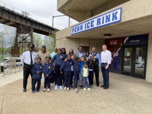 Photo of PAL officers and PAL participants in front of the Penn Ice Rink