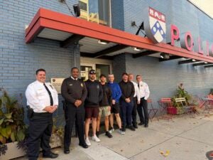 Members of the UPPD run club pose with command staff in front of DPS headquarters before the torch run.
