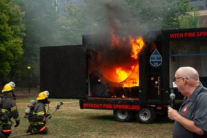 An image of the side-by-sded burn, as the room without sprinklers is fulled engulfed in flames
